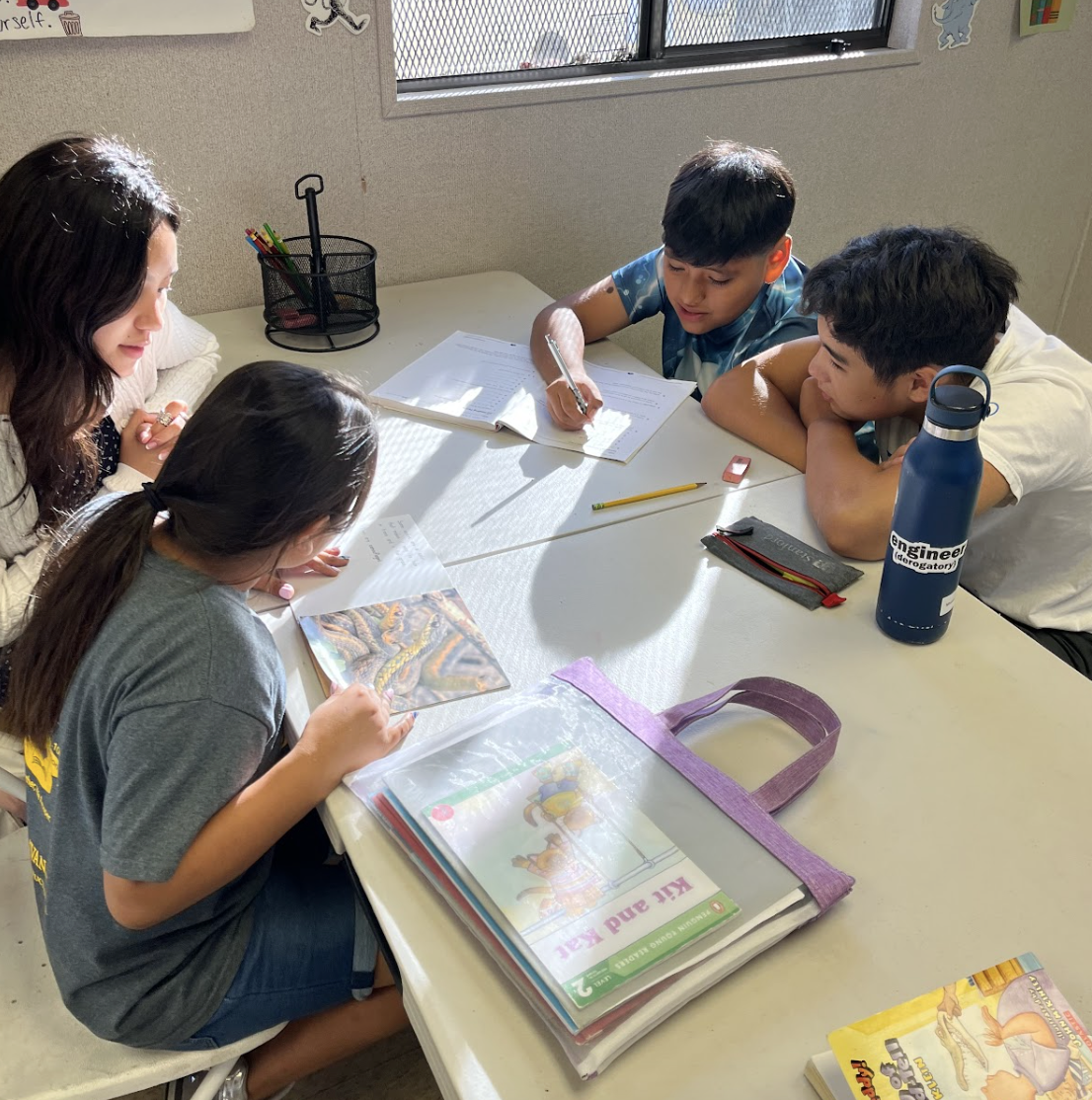 A Buena Vista Youth Scholars volunteer helps students with their homework.